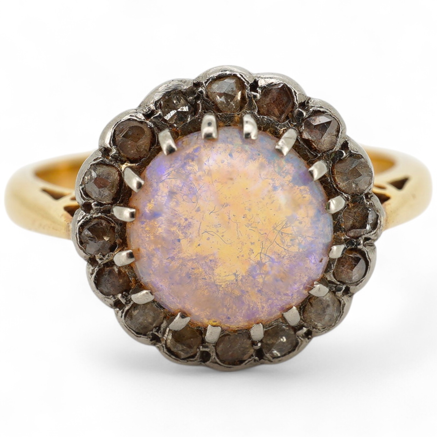 An early 20th century 18ct, opal and rose cut diamond set circular cluster ring, size N/O, gross weight 4.3 grams.